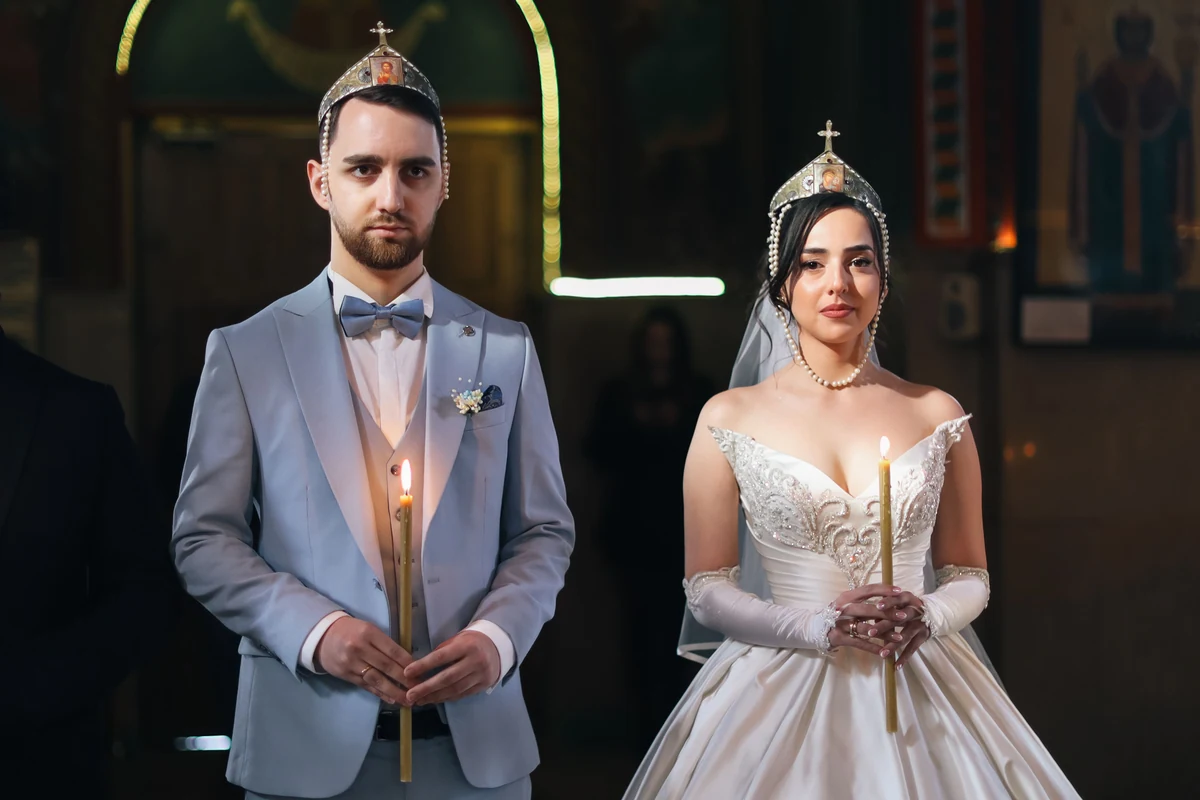 Kirkebryllup med brudepar ved alteret i en pyntet kirke